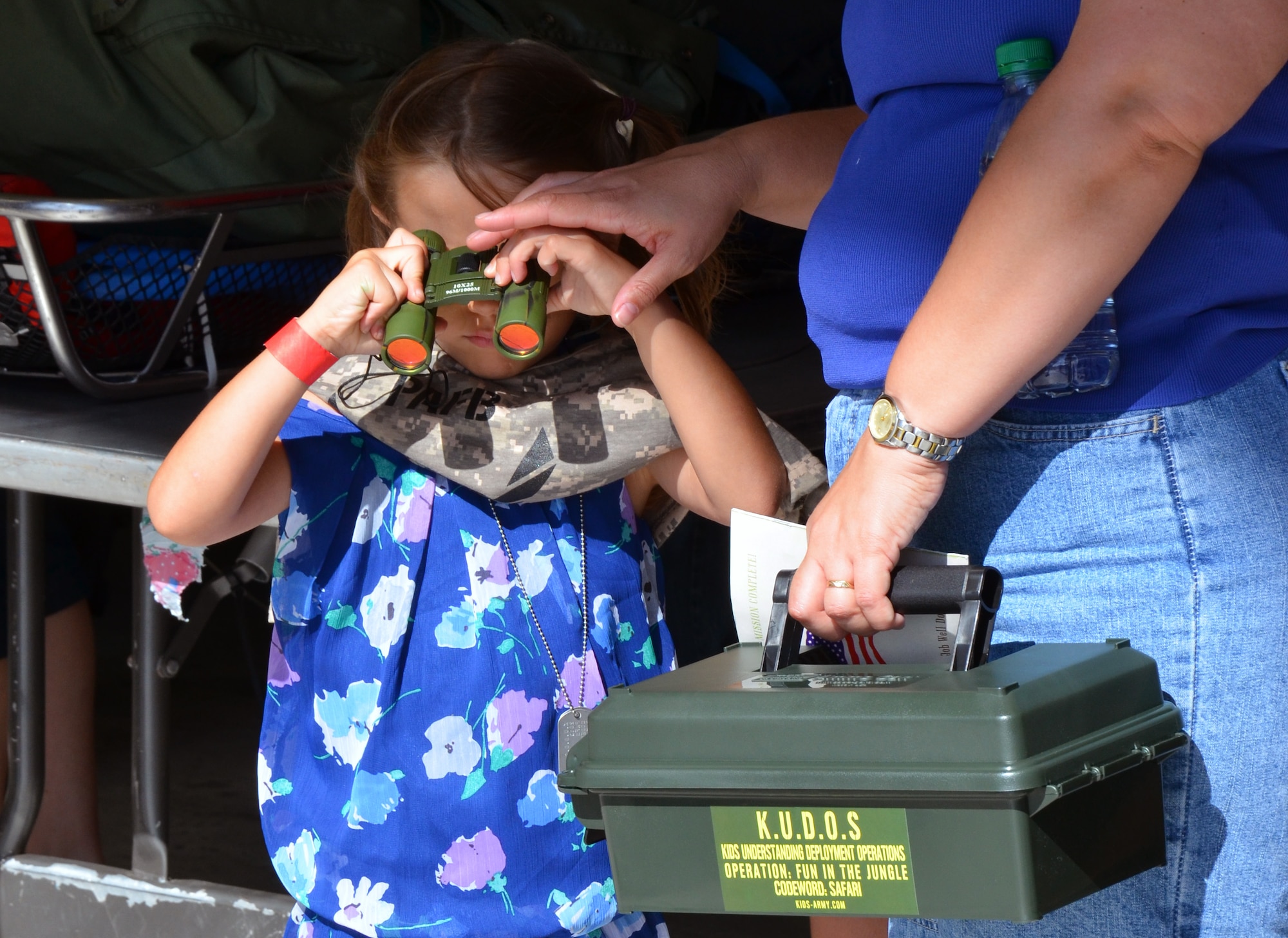 An Air Force-dependent child checks out her new binoculars during the Kids Understanding Deployment Operations event at Patrick Air Force Base June 1, 2013. (U.S. Air Force photo/Tech. Sgt. Anna-Marie Wyant)