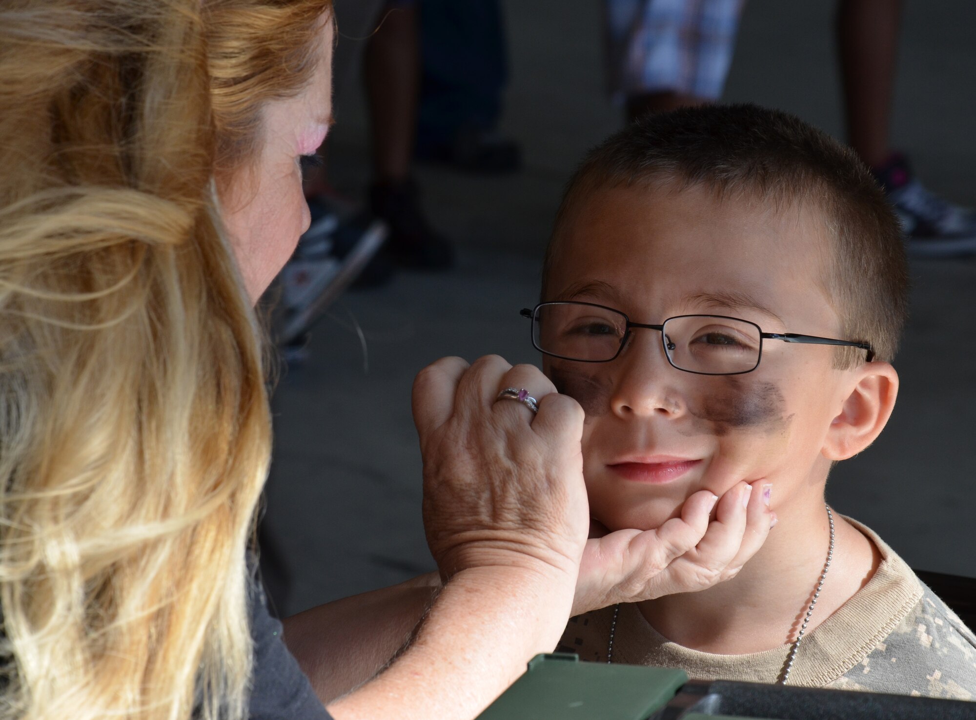 An Air Force-dependent child gets some camouflage face paint during the Kids Understanding Deployment Operations event at Patrick Air Force Base June 1, 2013. (U.S. Air Force photo/Tech. Sgt. Anna-Marie Wyant)
