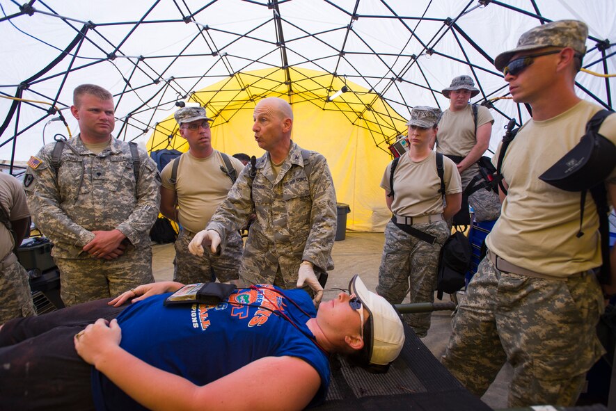 U.S. Air Force Col. Louis Perino, chief of aerospace medicine with the 116th Medical Group, Georgia Air National Guard, trains a group of U.S. Army Combat Medics on emergency lifesaving procedures during the Vigilant Guard 2013 exercise at Camp Blanding, Fla., May 21, 2013. The Medical Group from the 116th Air Control Wing, out of Robins Air Force Base, Ga., is a key component of the 78th Homeland Response Force set up to respond to disasters in the Southeast U.S. region. During the exercise, Guardsmen responded to various scenarios such as a plane crash, train derailment, hurricane, and an explosion at a chemical plant. (U.S. Air National Guard photo by Master Sgt. Roger Parsons/Released)