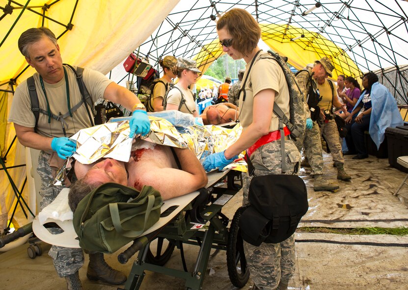 U.S. Air Force Lt. Col. Charles Drown, left, medical element commander with the 165th Medical Group, and Capt. Christal Lavelle a physicians assistant with the 116th Medical Group, Georgia Air National Guard, cover a simulated patient with an aluminum warming blanket during the Vigilant Guard 2013 exercise at Camp Blanding, Fla., May 21, 2013. The Medical Groups from the 116th Air Control Wing and the 165th Airlift Wing are a key component of the 78th Homeland Response Force set up to respond to disasters in the Southeast U.S. region. During the exercise, Guardsmen responded to various scenarios such as a plane crash, train derailment, hurricane, and an explosion at a chemical plant. (U.S. Air National Guard photo by Master Sgt. Roger Parsons/Released)