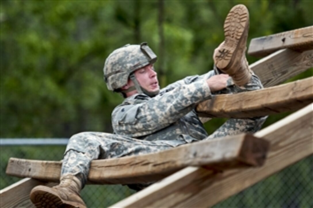 A paratrooper weaves through a ladder obstacle while competing in a team assault obstacle course competition that is part of the 82nd Airborne Division's  All-American week celebration on Fort Bragg, N.C., May 21, 2013. 