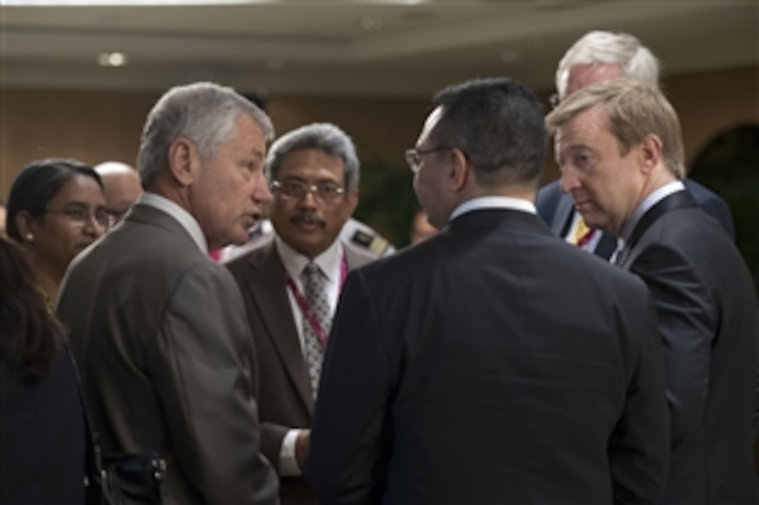 U.S. Defense Secretary Chuck Hagel speaks with defense ministers from Sri Lanka, Bangladesh, Sweden, New Zealand and Malaysia before an official lunch at the Shangri-La Dialogue in Singapore, June 1, 2013. 
