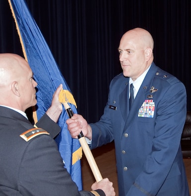 JOINT BASE ELMENDORF-RICHARDSON, Alaska -- Brig. Gen. Donald S. Wenke, commander of the Alaska Air National Guard's 176th Wing, receives his general officer flag from Maj. Gen. Thomas Katkus, Alaska's adjutant general, at a ceremony here June 2, 2013. National Guard photo by Capt. John Callahan.