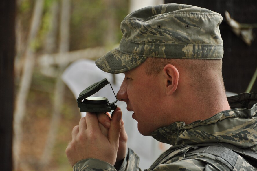 A Reserve Security Forces Squadron Airman sets his magnetic compass during a land navigation training course during the unit training assembly weekend June 1. The UTA's provide an opportunity for Traditional Reservists and full time Reservists to train together. (U.S. Air Force/Tech. Sgt. Dana Rosso)