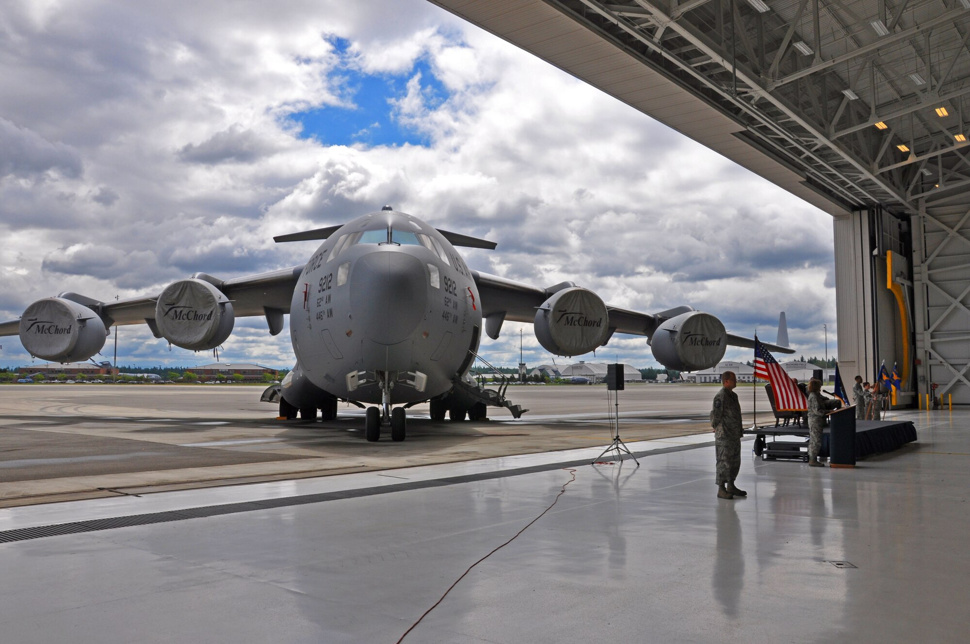 A C-17 Globemaster III sits on the runway on McChord Field outside of the hangar where the 446th Maintenance Group was changing command of it's squadrons June 2. Lt. Col. Maureen Carroll assumed command of the 446th Aircraft Maintenance Squadron and Lt. Col. Stephen Oliver assumed command of the 446th Maintenance Squadron. (U.S. Air Force Photo/Senior Master Sgt. Andrew Sax)
