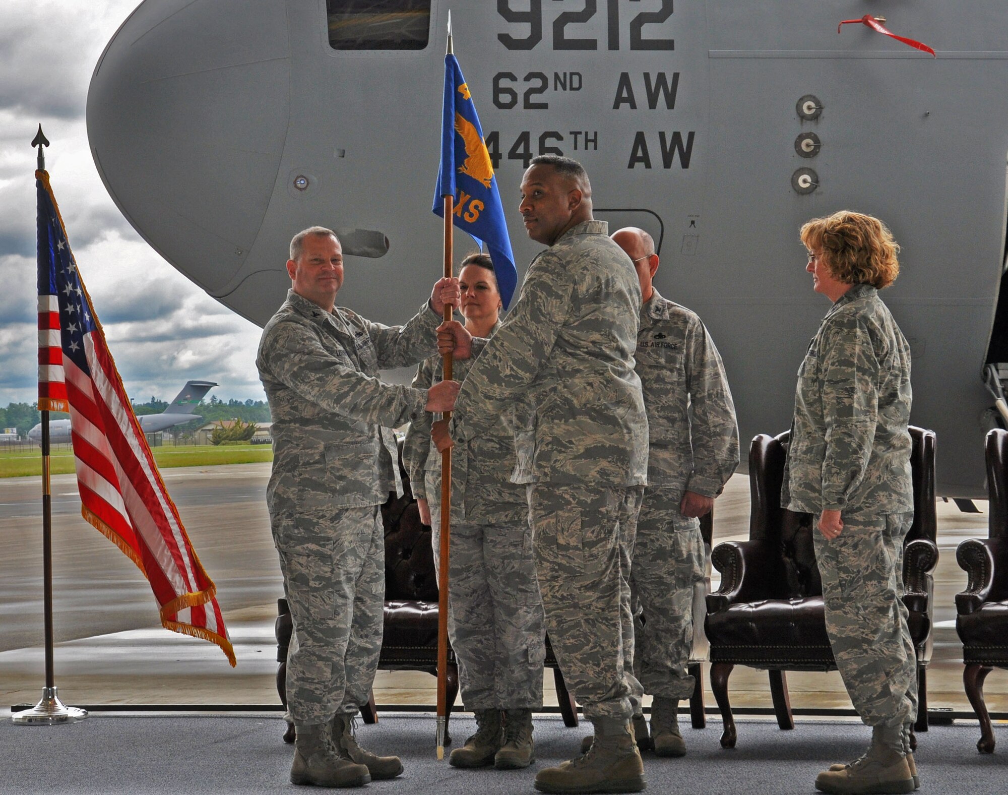 Col. Alan Lerner, 446th Maintenance Group commander, passes the 446th Maintenance Squadron guidon to Lt. Col. Stephen Oliver, former 446th Maintenance Operations Flight commander at McChord Field June 2. Oliver assumed command from Lt. Col. Maureen Carroll, who is now the commander of the 446th Aircraft Maintenance Squadron. (U.S. Air Force Photo/Senior Master Sgt. Andrew Sax)