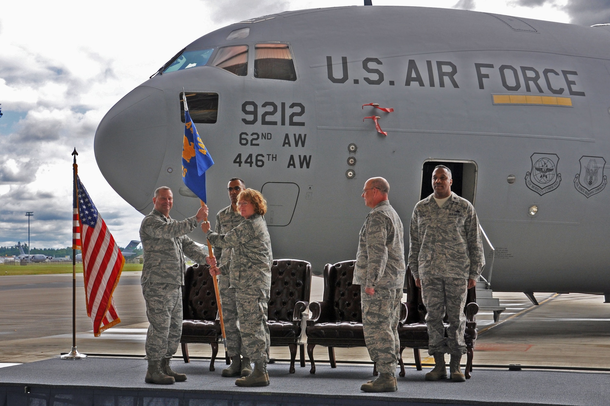 Col. Alan Lerner, 446th Maintenance Group commander, passes the 446th Aircraft Maintenance Squadron guidon to Lt. Col. Maureen Carroll, former 446th Maintenance Squadron commander on McChord Field June 2. In the same ceremony, Lt. Col. Stephen Oliver assumed command of the 446th MXS from Carroll after serving as the 446th Maintenance Operations Flight commander. (U.S. Air Force Photo/Senior Master Sgt. Andrew Sax)