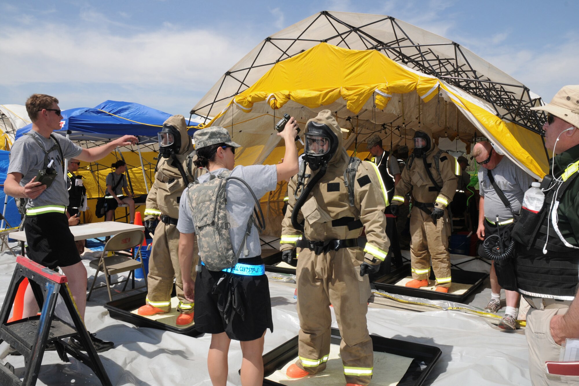 Members of the FSRT get sprayed down one final time before being able to remove their Lion MT94 Chemical Suits at Camp Ashland, Nebraska on May 15, 2013. The decontamination line is run by Soldiers from the Nebraska National Guard.  (U.S. Air National Guard photo by Tech. Sgt. Sara M. Robinson/Released)