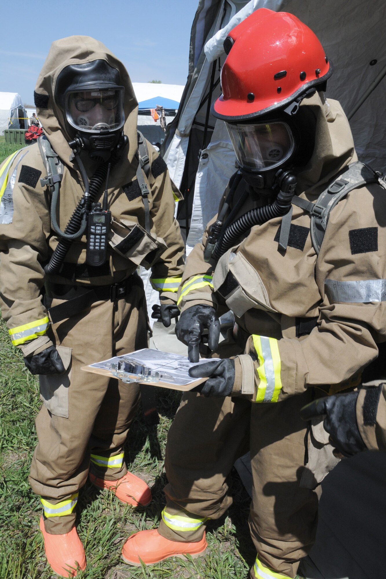 Staff Sgt. Ryan King (left), FSRT team member, and Staff Sgt. Jonathan Clayberg (right), FSRT team member review a site map for known fatalities before they enter the "hot zone" at Camp Ashland, Nebraska, on May 17, 2013. A reconnaissance team enters the area first and comes back with mark maps so the team can develop a plan for their recovery mission.  (U.S. Air National Guard photo by Tech. Sgt. Sara M. Robinson/Released)