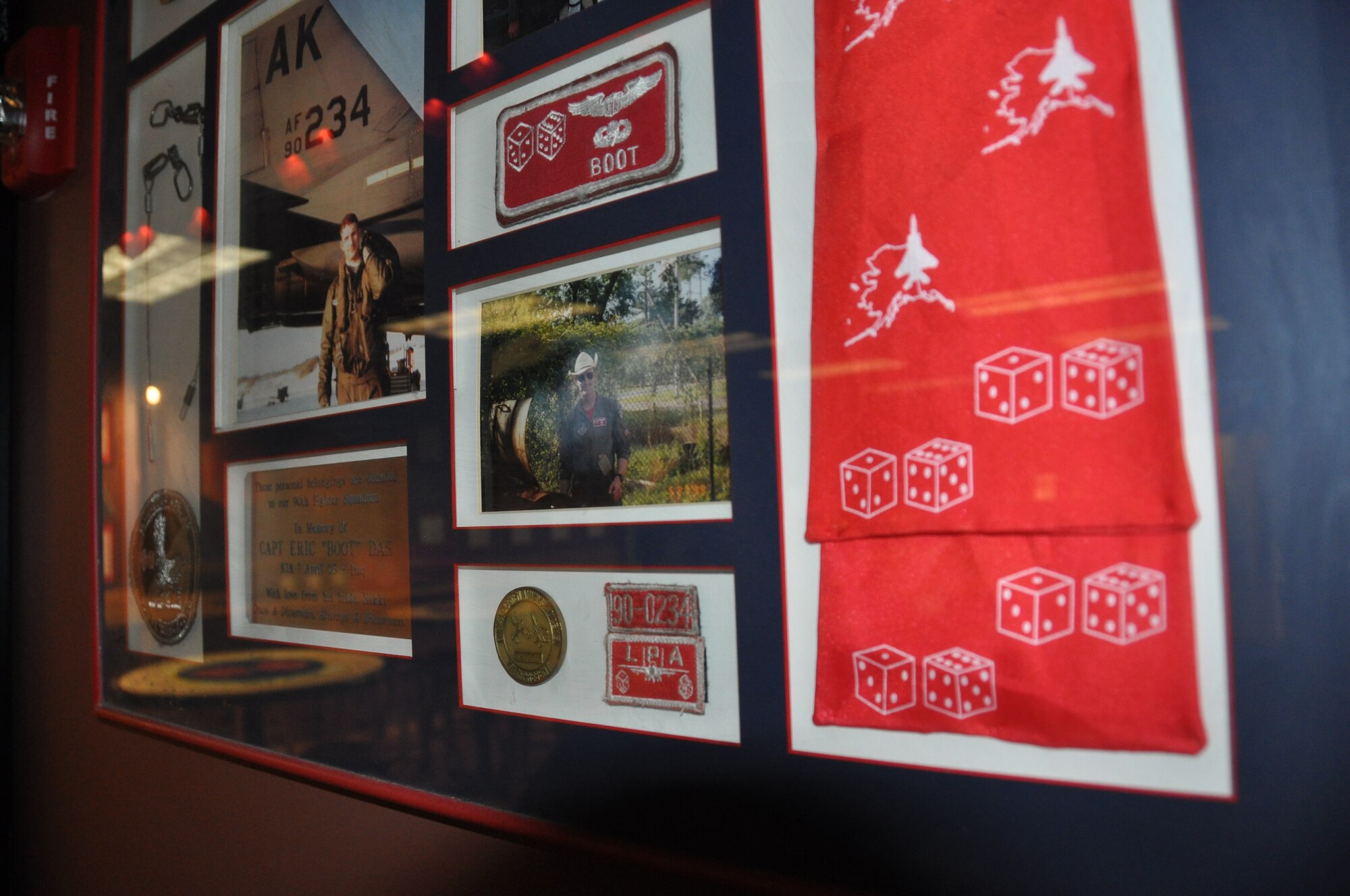 A memorial plaque that the Das family presented to the 90th FS with a photo, coin, scarf and other memorabilia belonging to Capt. Eric Das hangs in the 90th FS. 

"The 90th FS heritage holds a special place in my family's heart given the
camaraderie that they showed us over the years. Many Dicemen have served as
our family's source of support," said Capt. N.C. Das. "[Seeing his plaque on the wall]
doesn't make me sad. It makes me proud. I try to carry myself in a way that
honors Eric's memory - what he lived and what he died for." (U.S. Air Force/Capt. Ashley Conner) 
