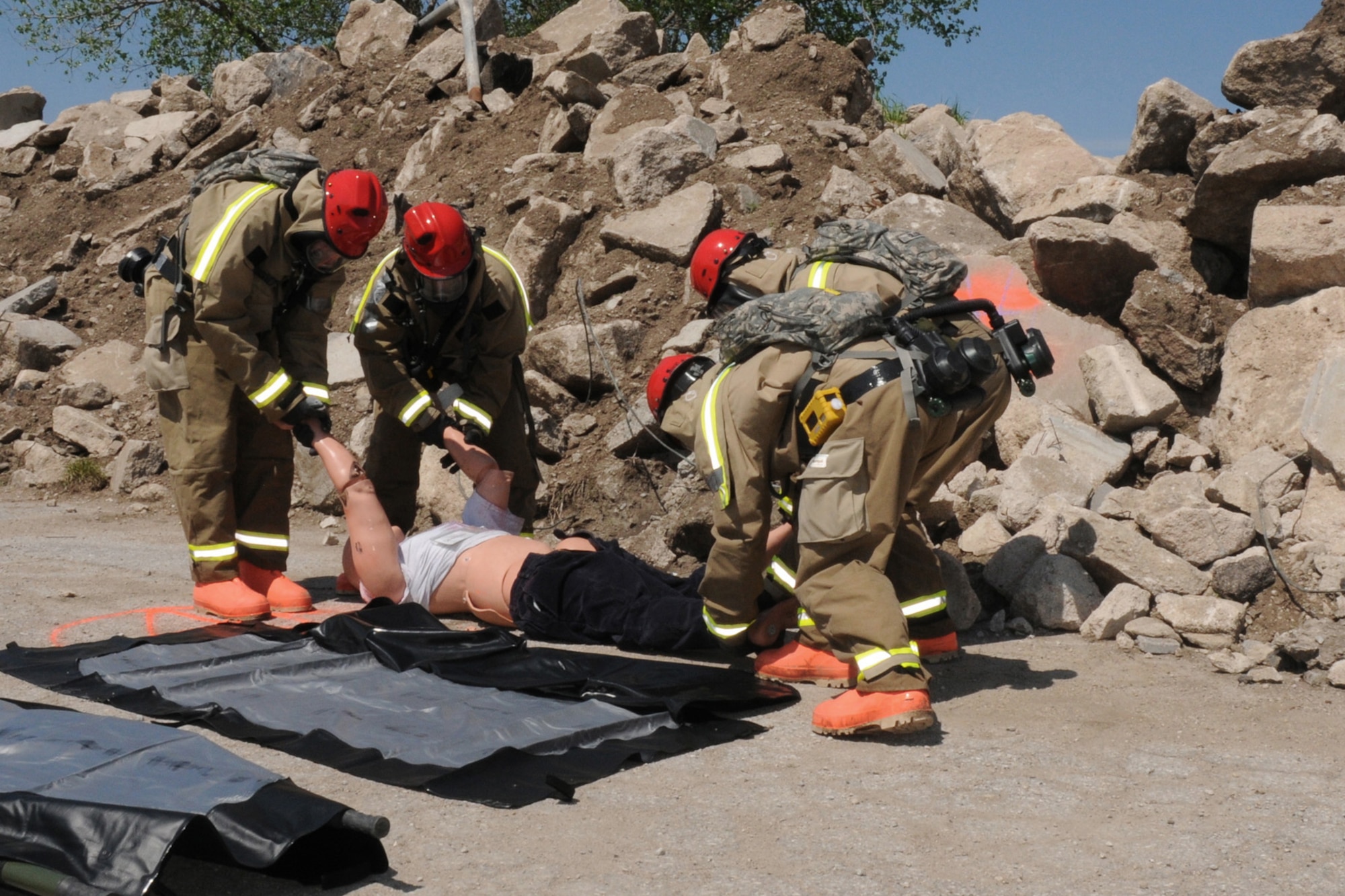 The FSRT team loads a 200 pound mannequin onto a litter to be removed from the "hot zone" at Camp Ashland, Nebraska on May 17, 2013. Mannequins are used to represent casualties to make the scenario as realistic as possible for the team.  (U.S. Air National Guard photo by Tech. Sgt. Sara M. Robinson/Released)