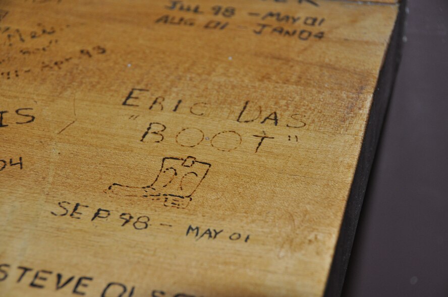 Capt. Eric Das’s name is etched into the bar in 90th FS heritage room. Das and his wife met when he was assigned to the 90th FS from 1998 to 2001.  After getting married the couple was deployed to Southwest Asia together in 2003.  April 7, 2003 he was killed when the F-15E he was flying crashed. (U.S. Air Force/Capt. Ashley Conner) 