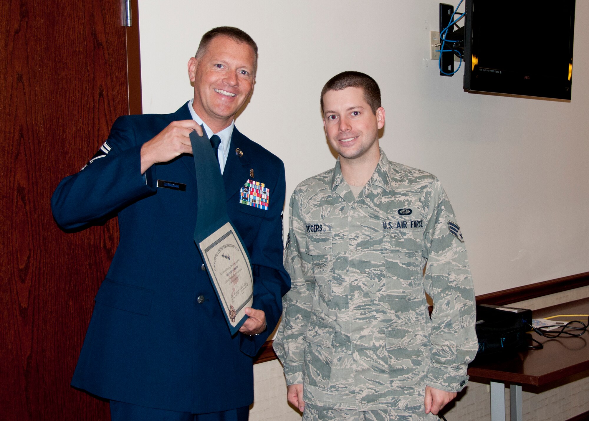 Senior Airman Nathan Rogers 914th Airlift Wing finance specialist is awarded the Top Three Group Award by Senior Master Sgt. Glen Ignasiak during commander’s call, June 1, 2013, Niagara Falls Air Reserve Station, N.Y. Rogers was recognized by his fellow airmen for his outstanding contribution to the Wing.(U.S. Air Force photo by Tech. Sgt. Joseph McKee) 