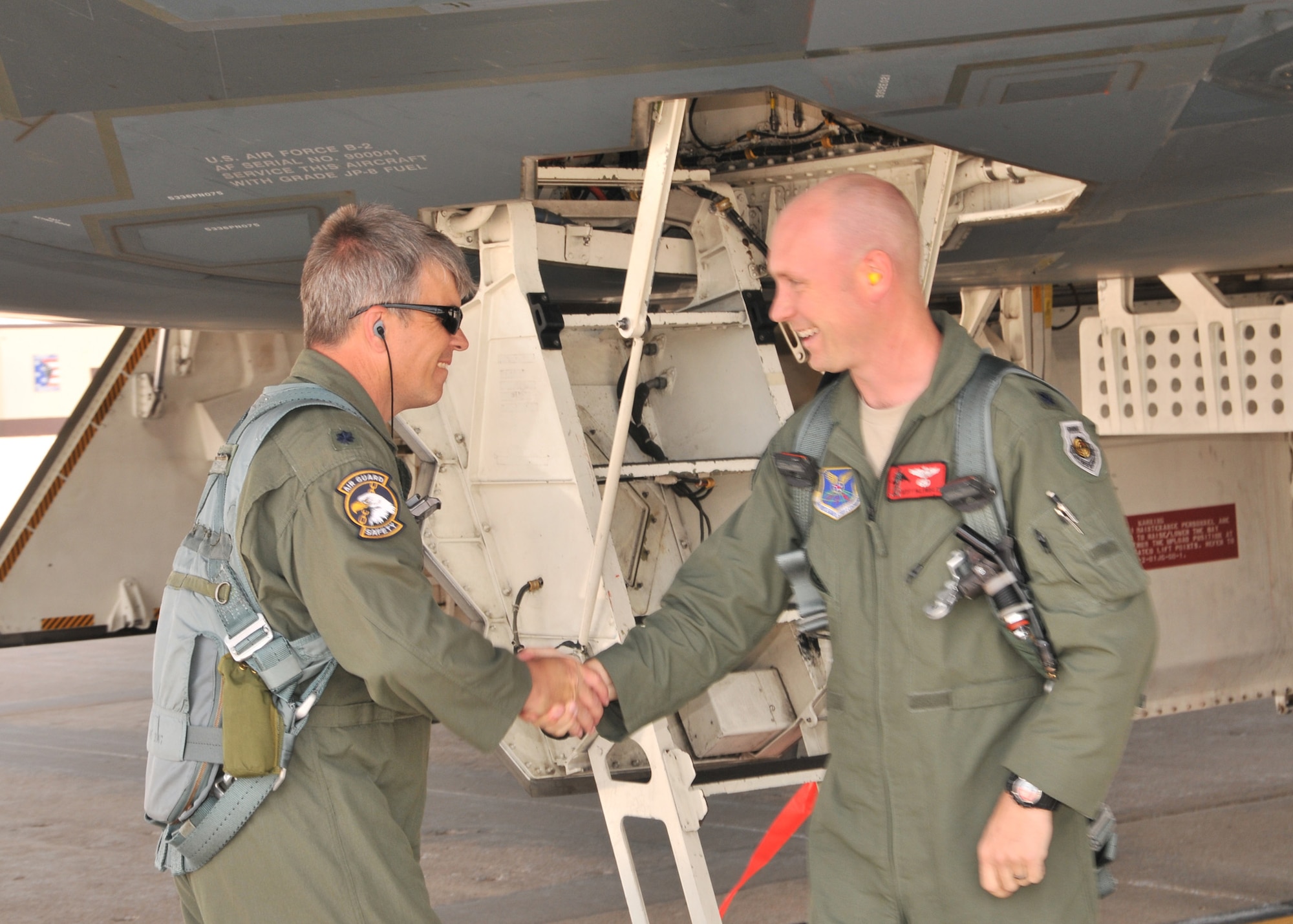 Lt. Col. Michael Means (left) greets Lt. Col. Geoff Billingsley at the hatch to the B-2 "Spirit of Hawaii" during their fini flights, June 1, 2013, Whiteman AFB. Both pilots, members of the 131st Bomb Wing, Missouri Air National Guard, are moving on to new job assignments. Billingsley, who has over 1200 B-2 flying hours, is departing the aircraft and Means is continuing on for his own final flight.  Means holds the B-2 flying hours record for the Air National Guard with 1765.8 hours and is second ranking of both active and guard pilots (retired and currently flying). (U.S. National Guard Photo by Senior Master Sgt. Mary-Dale Amison/RELEASED)