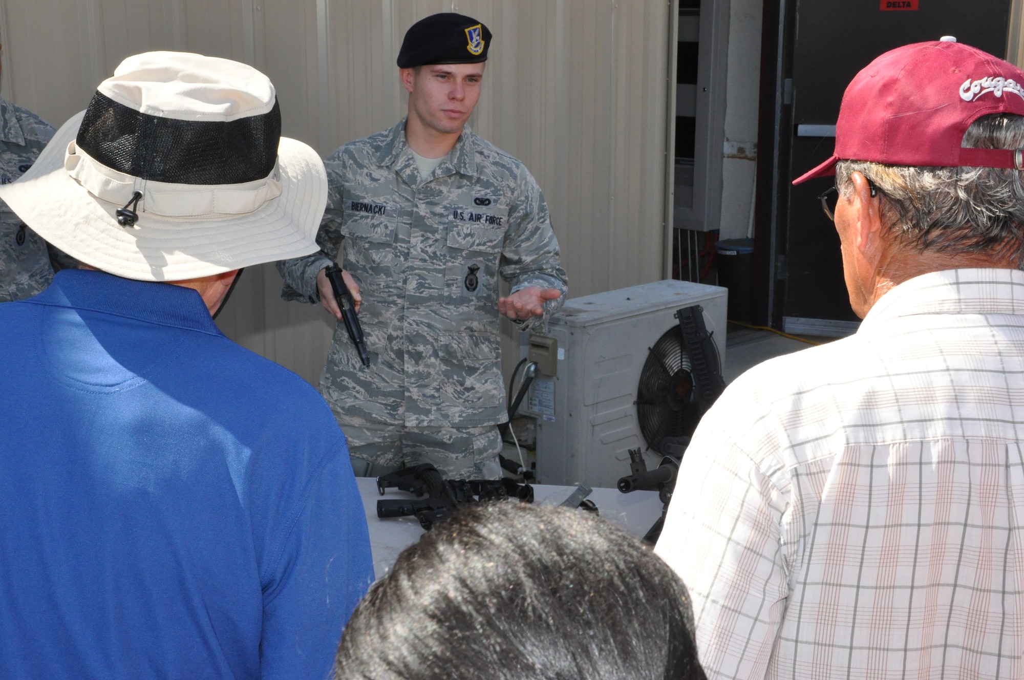 Senior Airman Adam Beirnacki, 940th Security Forces Squadron, describes the Berretta 9mm handgun to a group of employers.  Employers and civic leaders attended the annual ESGR tour at Beale during the June UTA. (U.S. Air Force photo Senior Airman Adam Hamar)