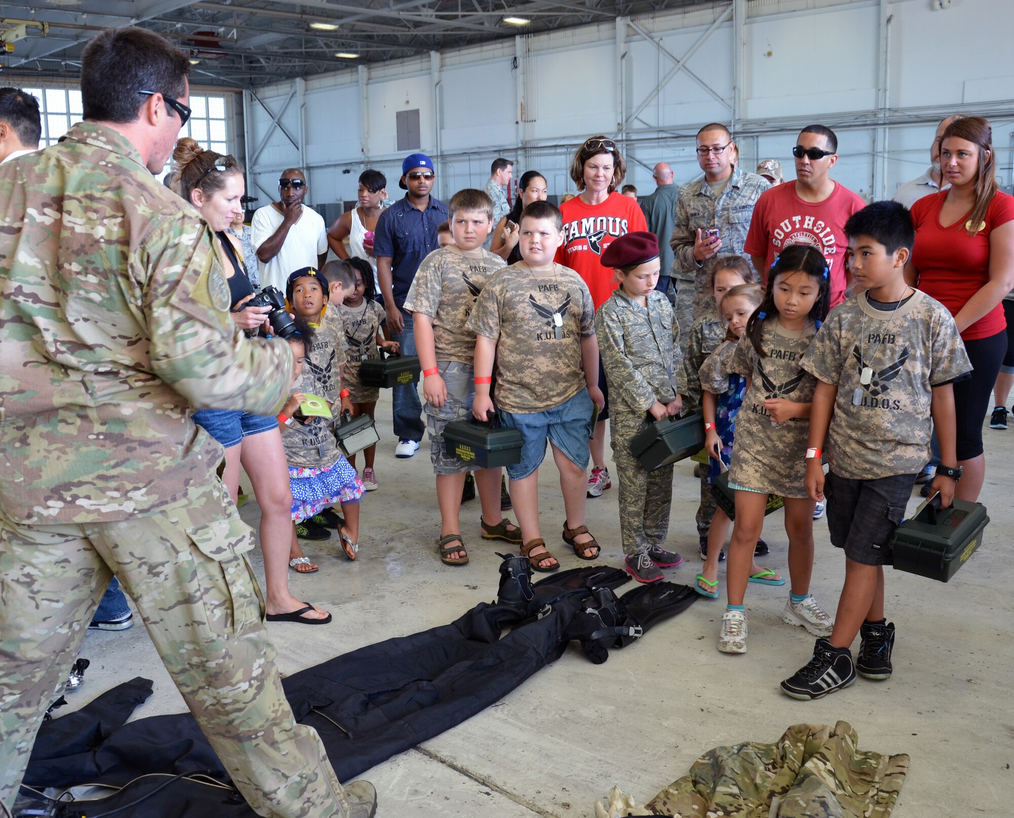 An Air Force Reserve pararescueman from the 308th Rescue Squadron answers kids’ questions about different pararescue gear during the Kids Understanding Deployment Operations event at Patrick Air Force Base June 1, 2013. (U.S. Air Force photo/Tech. Sgt. Anna-Marie Wyant)