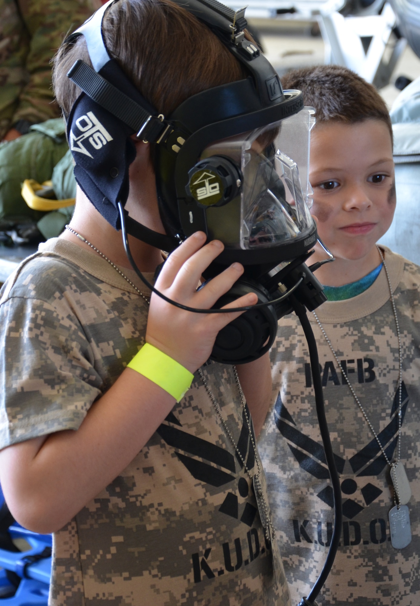 An Air Force-dependent child tries on a gas mask during the Kids Understanding Deployment Operations event at Patrick Air Force Base June 1, 2013. (U.S. Air Force photo/Tech. Sgt. Anna-Marie Wyant)