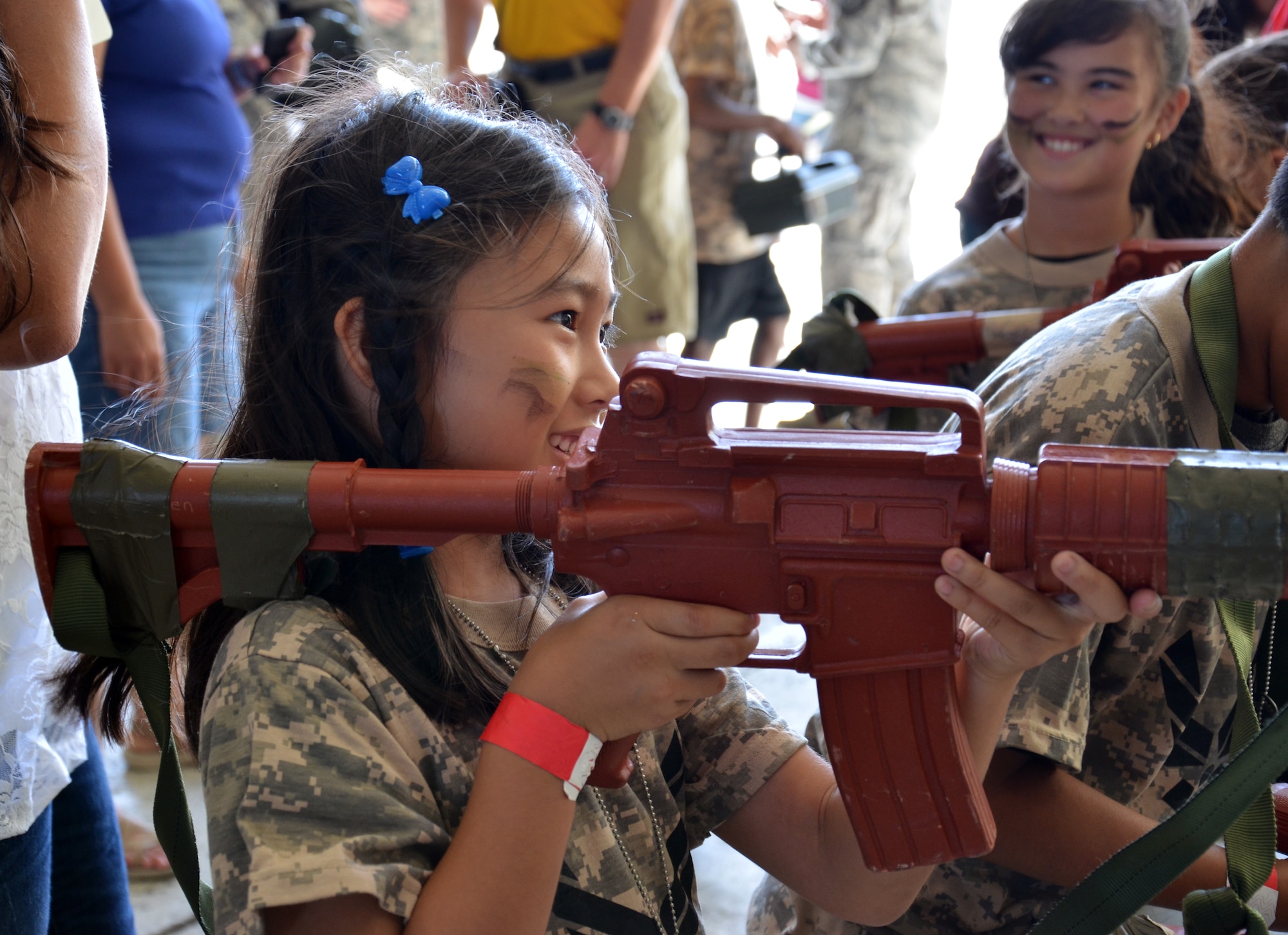 An Air Force-dependent child holds a dummy rifle during the Kids Understanding Deployment Operations event at Patrick Air Force Base June 1, 2013. (U.S. Air Force photo/Tech. Sgt. Anna-Marie Wyant)