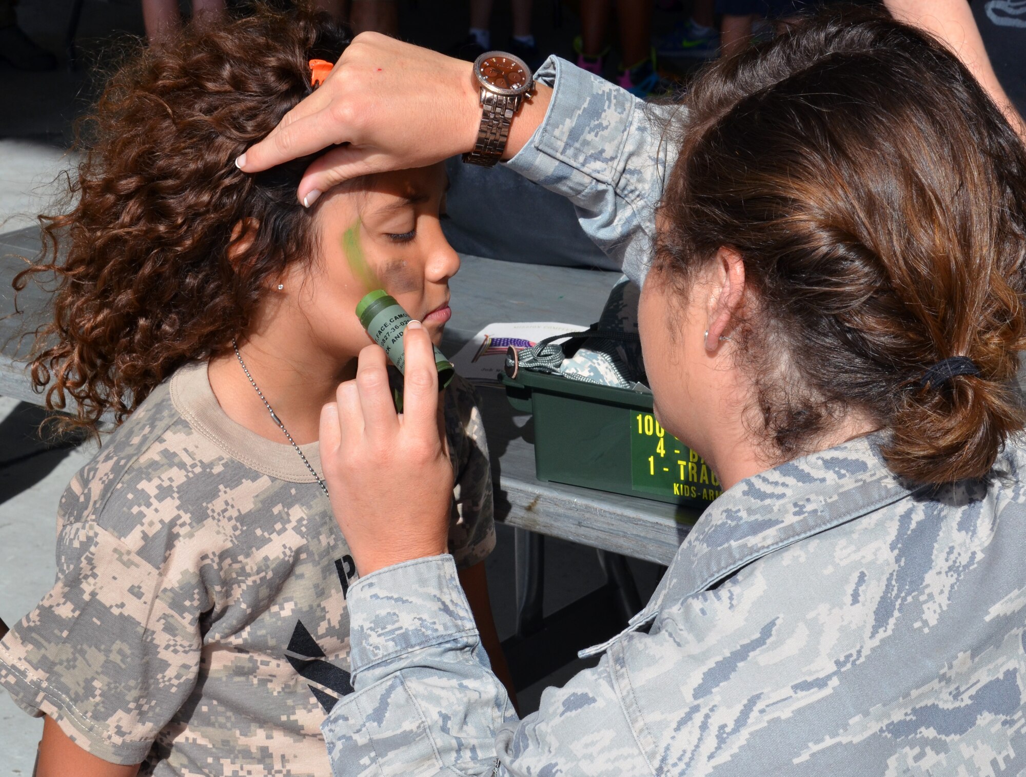 An Air Force-dependent child gets some camouflage face paint during the Kids Understanding Deployment Operations event at Patrick Air Force Base June 1, 2013. (U.S. Air Force photo/Tech. Sgt. Anna-Marie Wyant)
