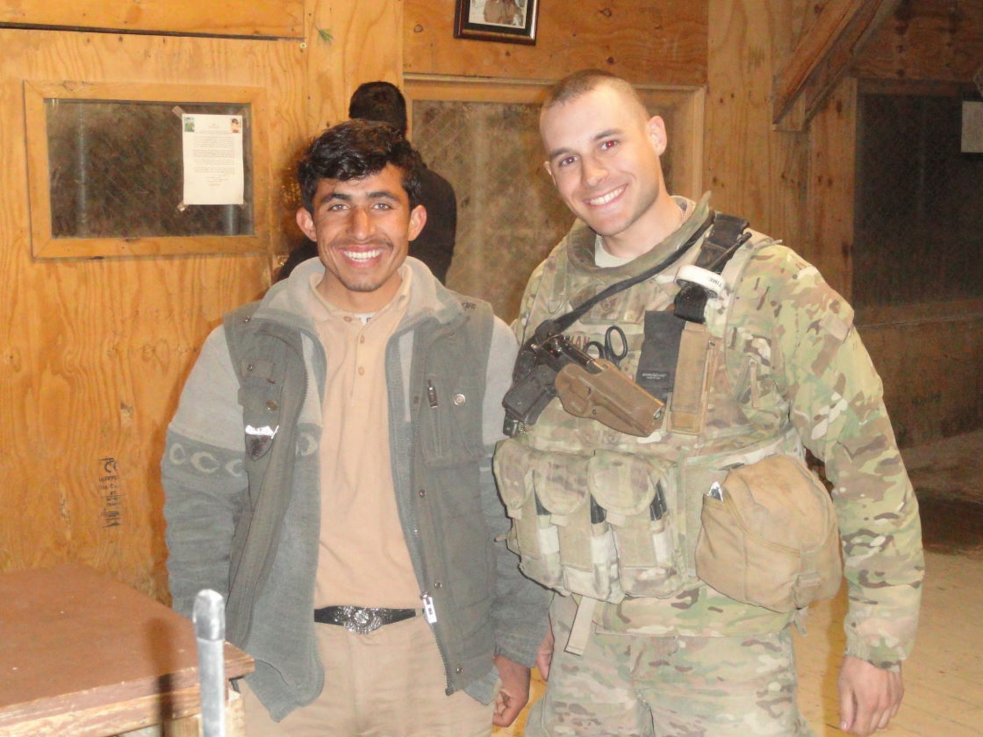 Staff Sgt. Samuel Lerman (right), 459th Security Forces Squadron, poses for a photo with Safiullah, an Afghan contractor, during a 2011 deployment to Bagram Air Field, Afghanistan. Lerman utilized Self-Aid-And-Buddy-Care training he received at Joint Base Andrews, Md., to help save Safiullah's life following a rocket attack during his deployment. After healing from his wounds, Safiullah returned to work shortly before Lerman completed his Afghanistan tour. (Submitted photo)