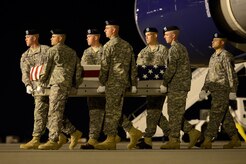 A U.S Army carry team transfers the remains of Staff Sgt. Joe A. Nunezrodriguez of Pasadena, Texas, during a dignified transfer June 1, 2013, at Dover Air Force Base, Del. Nunezrodriguez was assigned to the 68th Combat Support Battalion, 43rd Sustainment Brigade, 4th Infantry Division, Fort Carson, Colo. (U.S. Air Force photo/Greg L. Davis)