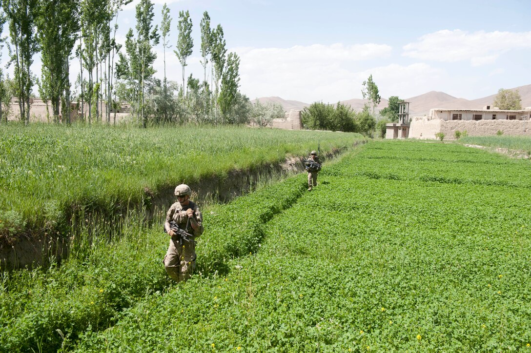U.S. soldiers patrol through a field toward an observation point to counteract indirect fire near Combat Outpost Baraki Barak in Afghanistan’s Logar province, May 21, 2013.