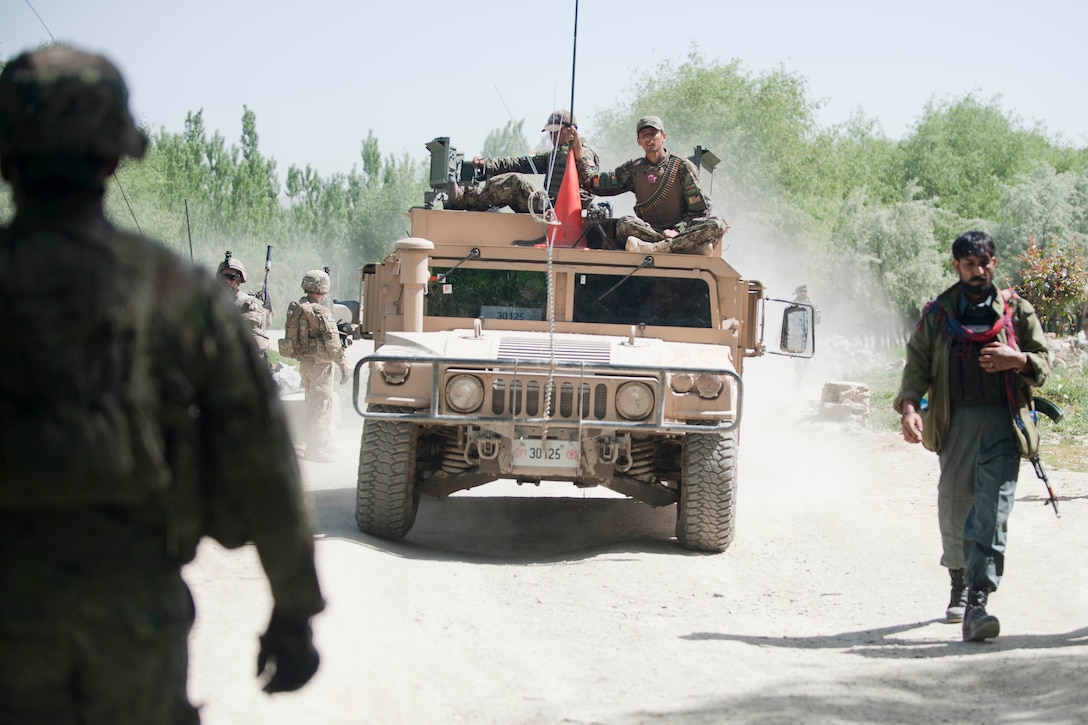 U.S., Afghan soldiers and Afghan police conduct a presence patrol and ...