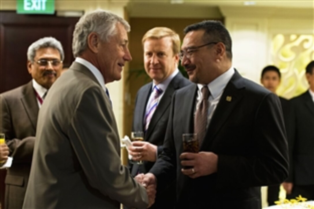 U.S. Defense Secretary Chuck Hagel greets Malaysian Defense Minister Hishammuddin Hussein before an official lunch at the Shangri-La Dialogue in Singapore, June 1, 2013.  