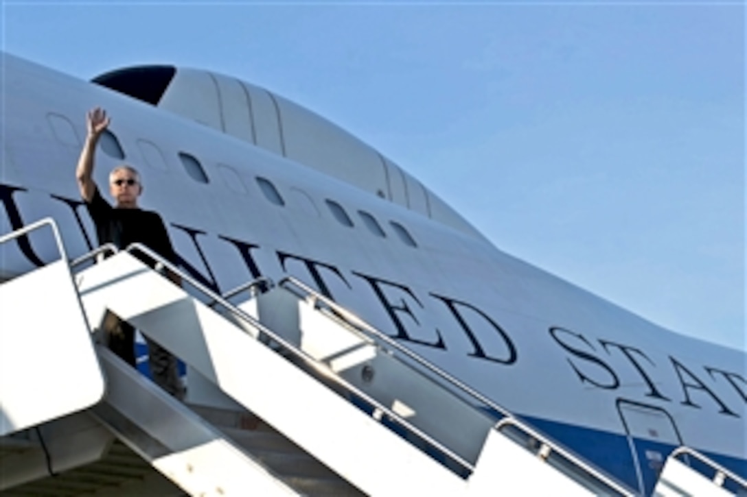 U.S. Defense Secretary Chuck Hagel waves goodbye as he departs Singapore, June 3, 2013. Hagel will conclude his weeklong trip in Brussels, where he plans to meet with defense ministers at NATO headquarters.