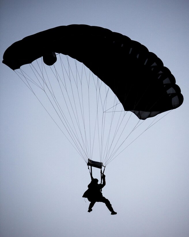 A 26th Marine Expeditionary Unit (MEU) Maritime Raid Force Marine descends to a landing zone while conducting parachute operations over Djibouti, Africa, May 27, 2013. The 26th MEU is a Marine Air-Ground Task Force forward-deployed to the U.S. 5th Fleet area of responsibility aboard the Kearsarge Amphibious Ready Group serving as a sea-based, expeditionary crisis response force capable of conducting amphibious operations across the full range of military operations.(U.S. Marine Corps photo by Sgt. Christopher Q. Stone, 26th MEU Combat Camera/Released)