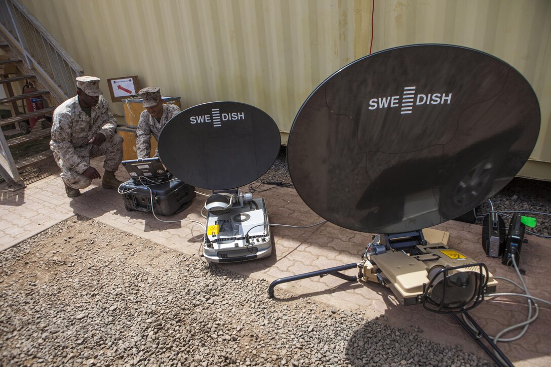 Communications Marines assigned to 26th Marine Expeditionary Unit (MEU), work with a SWE-DISH satellite communications system aboard Camp Lemonnier in Djibouti, Africa, May 27, 2013. The 26th MEU is a Marine Air-Ground Task Force forward-deployed to the U.S. 5th Fleet area of responsibility aboard the Kearsarge Amphibious Ready Group serving as a sea-based, expeditionary crisis response force capable of conducting amphibious operations across the full range of military operations.(U.S. Marine Corps photo by Sgt. Christopher Q. Stone, 26th MEU Combat Camera/Released)