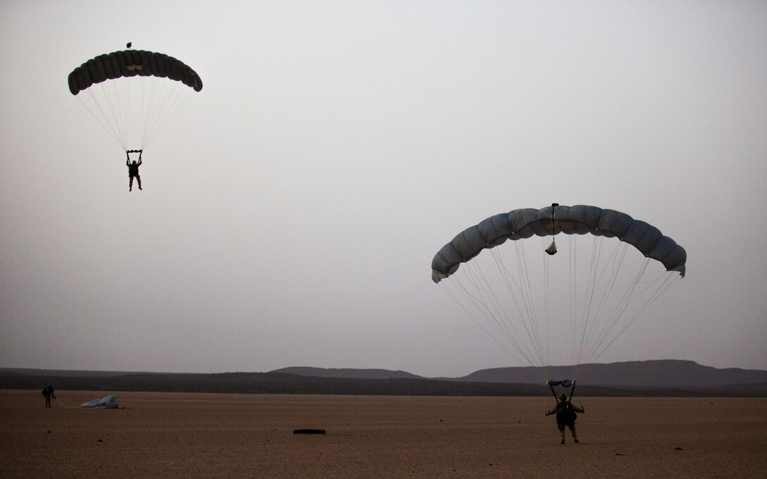 26th Marine Expeditionary Unit (MEU) Maritime Raid Force Marines descend to a landing zone while conducting parachute operations over Djibouti, Africa, May 27, 2013. The 26th MEU is a Marine Air-Ground Task Force forward-deployed to the U.S. 5th Fleet area of responsibility aboard the Kearsarge Amphibious Ready Group serving as a sea-based, expeditionary crisis response force capable of conducting amphibious operations across the full range of military operations.(U.S. Marine Corps photo by Sgt. Christopher Q. Stone, 26th MEU Combat Camera/Released)