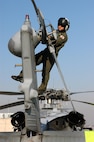 Aviation Warfare Systems Specialist 3rd Class Zach Sykora, attached to Helicopter Sea Combat Squadron Eight Five (HSC) 85, performs a pre-flight inspection on a MH-60s Seahawk helicopter before take off.  HSC-85 has teamed up with the San Diego California Department of Forestry and Fire Protection to put out the wild fires blazing across Southern California.  U.S. Navy photo by Mass Communication Specialist 3rd Class Dustin Kelling.  