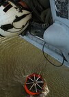 Chief Aviation Electronics Mate (AW/NAC) Rexford Sackett from the "High Rollers" of Helicopter Sea Combat Squadron (HSC) 85 monitors the altitude of a Navy MH-60S "Seahawk" Tuesday that was specially equipped with a 420-gallon capacity Bambi bucket as it is filled with water.

The High Rollers flew two MH-60S each specially equipped with a 420-gallon capacity Bambi bucket used to drop water in coordination with civillian fire fighters. 

