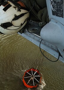 Chief Aviation Electronics Mate (AW/NAC) Rexford Sackett from the "High Rollers" of Helicopter Sea Combat Squadron (HSC) 85 monitors the altitude of a Navy MH-60S "Seahawk" Tuesday that was specially equipped with a 420-gallon capacity Bambi bucket as it is filled with water.

The High Rollers flew two MH-60S each specially equipped with a 420-gallon capacity Bambi bucket used to drop water in coordination with civillian fire fighters. 

