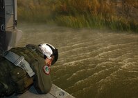 Aviation Warfare Systems Operator 3rd Class (NAC) William Quadrino from the "High Rollers" of Helicopter Sea Combat Squadron (HSC) 85 monitors the altitude of a Navy MH-60S "Seahawk" Tuesday that was specially equipped with a 420-gallon capacity Bambi bucket as it is filled with water.

The High Rollers flew two MH-60S each specially equipped with a 420-gallon capacity Bambi bucket used to drop water in coordination with civillian fire fighters. 

