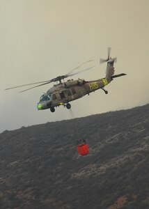 A Navy MH-60S "Seahawk" from the "High Rollers" of Helictoper Sea Combat Squadron (HSC) 85 prepares to fill a 420-gallon capacity Bambi bucket Tuesday used to drop water in coordination with civillian fire fighters. 

HSC-85 flew two MH-60S each specially equipped with a Bambi bucket.

U.S. Navy photo by Mass Communication Specialist 2nd Class (SW/AW) Chris Fahey.