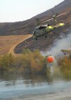 A Navy MH-60S "Seahawk" from the "High Rollers" of Helictoper Sea Combat Squadron (HSC) 85 lifts to the air after fillingl a 420-gallon capacity Bambi bucket Tuesday used to drop water in coordination with civillian fire fighters. 

HSC-85 flew two MH-60S each specially equipped with a Bambi bucket.

U.S. Navy photo by Mass Communication Specialist 2nd Class (SW/AW) Chris Fahey.