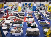 More than 380 military families in San Diego County and the surrounding area are taking refuge at the Naval Air Station North Island gymnasium after evacuating their homes due to encroaching wildfires.  More than a quarter-million people were urged to flee their homes across Southern California as wildfires blown by fierce desert winds raced over the landscape with terrifying speed, destroying hundreds of structures, clogging highways, sending smoke and ash over a wide area. The numerous fires in San Diego County currently threaten no Navy facilities. The Navy is working with various agencies to aide in combating the fires and providing assistance to both military and civilians.

 U.S. Navy photo by Mass Communication 2nd Class Mark A. Leonesio 