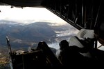 Air Force Tech. Sgt. Lamont Wood checks the positioning of the nozzles prior to deploying 3,000 gallons of fire retardant over the Poomacha Fire in North San Diego county, Calif. The C-130 and crew are assigned to the 302nd Airlift Wing, Peterson Air Force Base, Colo. The aircraft launched from Channel Islands Air National Guard Station, Calif., Oct., 24, 2007. The US Air Force Reserves is participating in the Southern California firefighting effort. 

