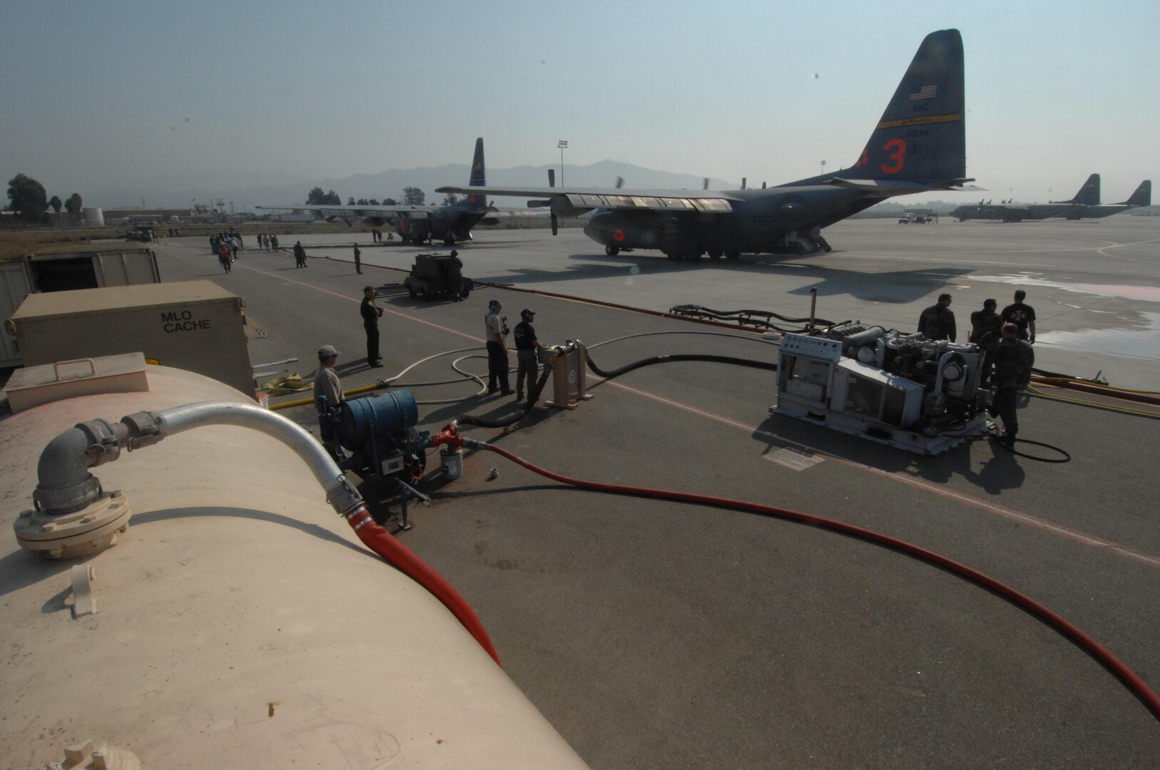 Civilians from the PHOS CHECK Air Attack Team, control the mixture of fire retardant powder being emptied out from it's bin in preparation for loading the mixture on to a C-130 as it prepares to launch from Channel Islands Air National Guard Station, Calif., on Oct. 25, 2007 in support of the California firefighting efforts. The U.S. Air Force Reserve and Air National Guard are participating in the Southern California firefighting effort. 
