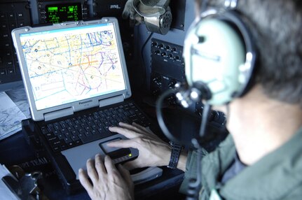Navigator, Lt. Colonel Robert Thomas supports the firefighting effort as his C-130 dumps 3,000 gallons of fire retardant over the Poomacha Fire in North San Diego county, Calif., Oct., 26, 2007. The C-130 and crew are assigned to the 302nd Airlift Wing, Peterson Air Force Base, Colo. The aircraft launched from Channel Islands Air National Guard Station, Calif.
