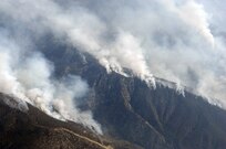 Heavy smoke hangs in the air as the Poomacha Fire in North San Diego county, Calif. continues to burn. C-130s launched from Channel Islands Air National Guard Station, Calif., Oct., 26, 2007 are participating in the Southern California firefighting effort. 