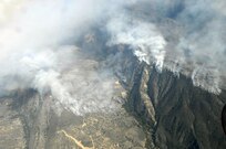 Heavy smoke hangs in the air as the Poomacha Fire in North San Diego county, Calif. continues to burn. C-130s launched from Channel Islands Air National Guard Station, Calif., Oct., 26, 2007 are participating in the Southern California firefighting effort. 