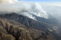 Heavy smoke hangs in the air as the Poomacha Fire in North San Diego county, Calif. continues to burn. C-130s launched from Channel Islands Air National Guard Station, Calif., Oct., 26, 2007 are participating in the Southern California firefighting effort. 