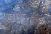 Fire retardant lines are placed in front of the advancing Poomacha fire burning in the Mount Palomar area. C-130s launched from Channel Islands Air National Guard Station, Calif., Oct., 26, 2007 are participating in the Southern California firefighting effort. 