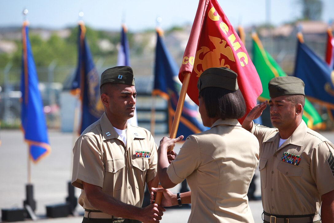 Captain Arun Shankar, left, incoming commanding officer, Communications Company, Combat Logistics Regiment 17, 1st Marine 
Logistics Group, takes the company’s guidon from Capt. NaTasha M. Everly, outgoing commanding officer, during a change of command 
ceremony aboard Camp Pendleton, Calif., May 31, 2013. Shankar, a native of Houston, expressed his enthusiasm for the opportunity to work with the Communications Company Marines in the future.