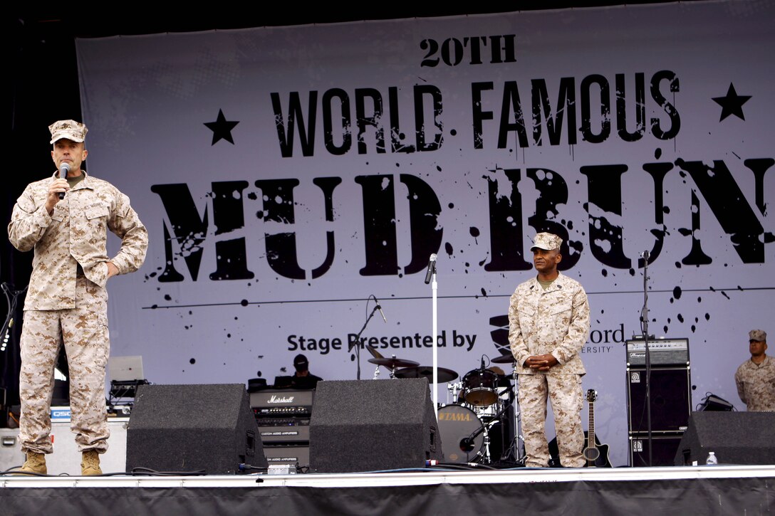 Brig. Gen. Vincent A. Coglianese, left, Sgt. Maj. Derek Christovale Sr., center, and Chief Warrant Officer 4 Anthony Cisneros, right, give opening remarks before the 20th annual World Famous Mud Run here June 1. Several obstacles were incorporated into the 10K, which started at Lake O’Neil, and took the runners through training areas 26 and 27of the base.