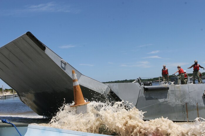 A Navy lighterage vessel splashes to shore during a Marine Prepositioning Force Exercise conducted aboard Marine Corps Support Facility Blount Island, Fla., May 25, 2013. Lighterage vessels were used to transport equipment from the United States Naval Ship Dahl to shore. (U.S. Marine Corps photo by Lance Cpl. Shawn Valosin)