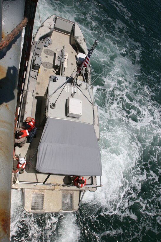A UV boat carrying service members from II Marine Expeditionary Force and sailors from Beach Master Unit Two docks against the United States Naval Ship Dahl to allow members to board the ship. Service members from both groups lived aboard the Dahl during a Marine Prepositioning Force Exercise conducted aboard Marine Corps Support Facility Blount Island, Fla., May 25-30, 2013. (U.S. Marine Corps photo by Lance Cpl. Shawn Valosin)